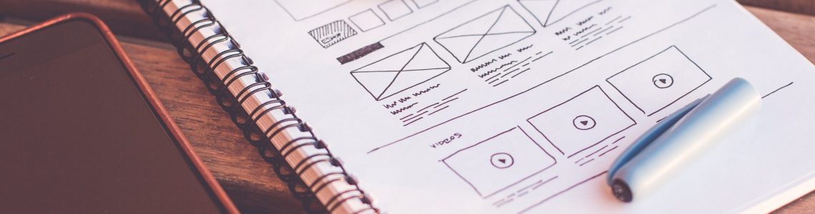 notebook-beside-the-iphone-on-table-196644